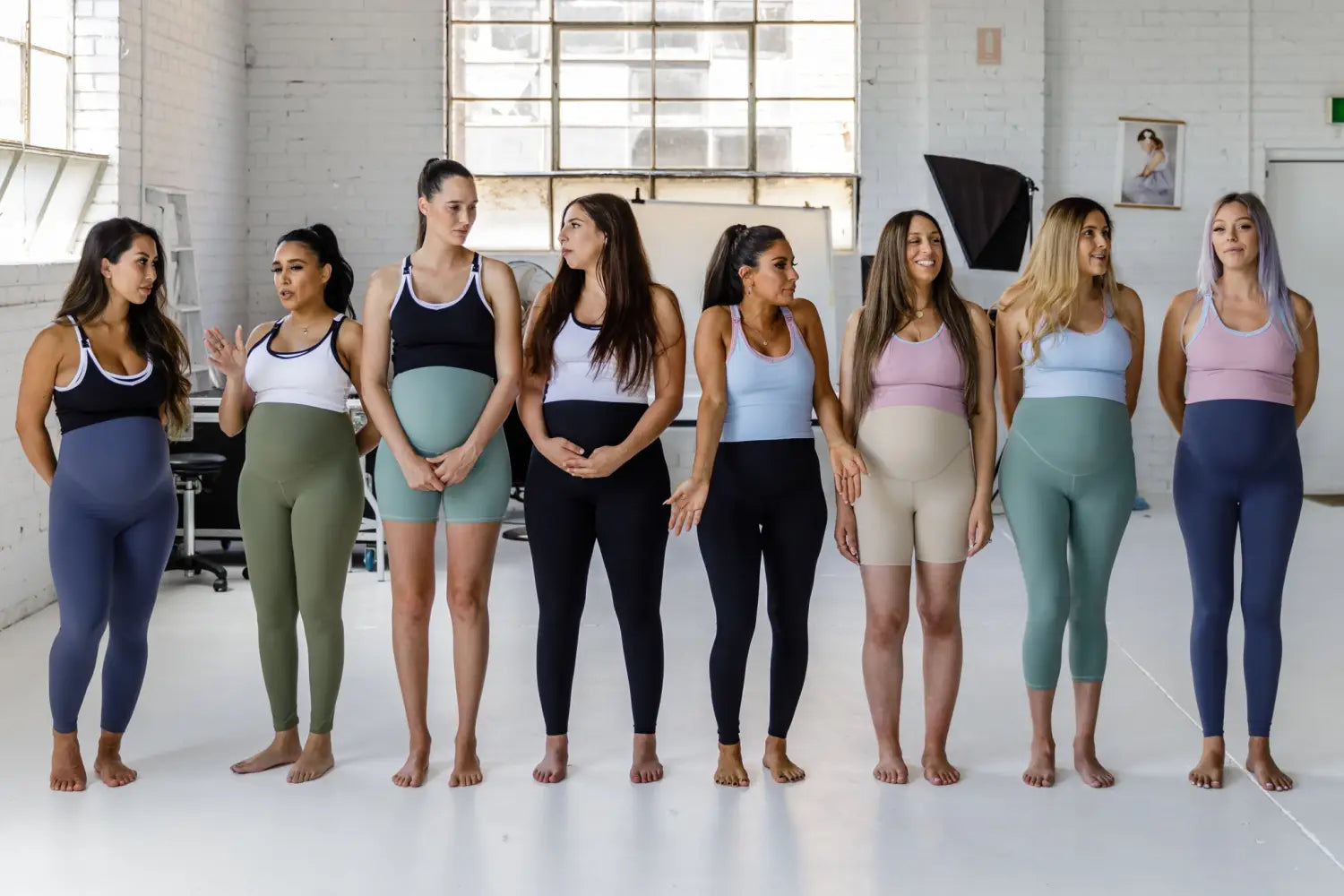 Group of women in yoga leggings ready for a yoga session in athletic attire.